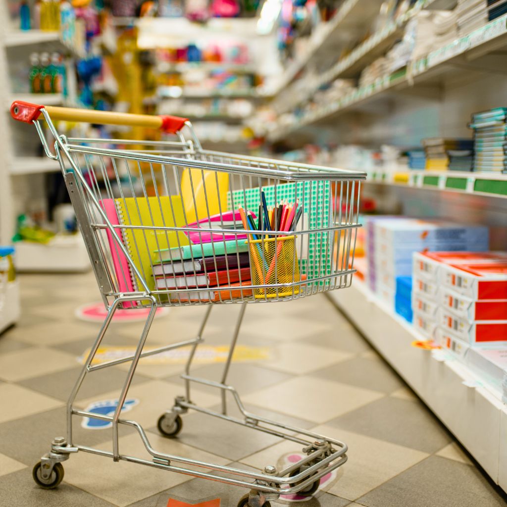 A shopping cart loaded with books and other goods, highlighting the Tax Free Weekend in Dallas Fort Worth.