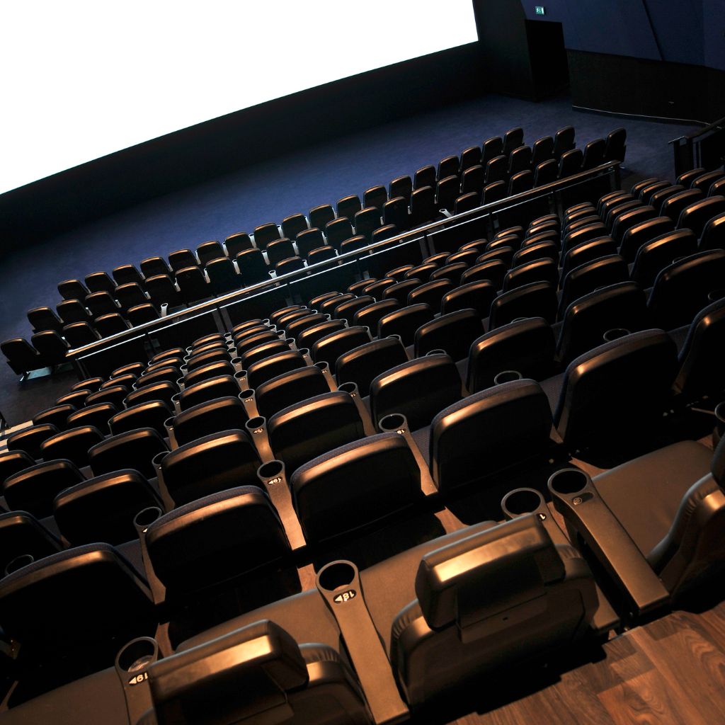 A young girl is climbing a rock wall at The Smurf Experience, part of the exciting kids' activities in Dallas this August.